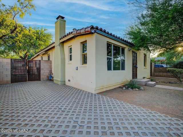 view of side of home with a patio area