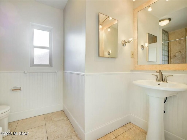 bathroom with toilet and tile patterned floors