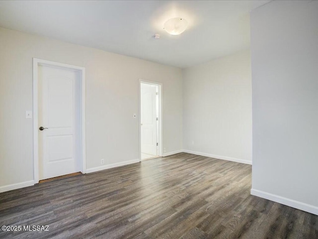 empty room with dark hardwood / wood-style floors