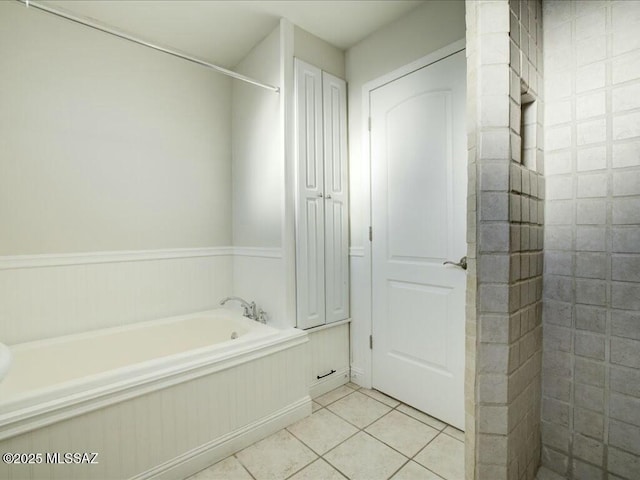 bathroom with independent shower and bath and tile patterned floors