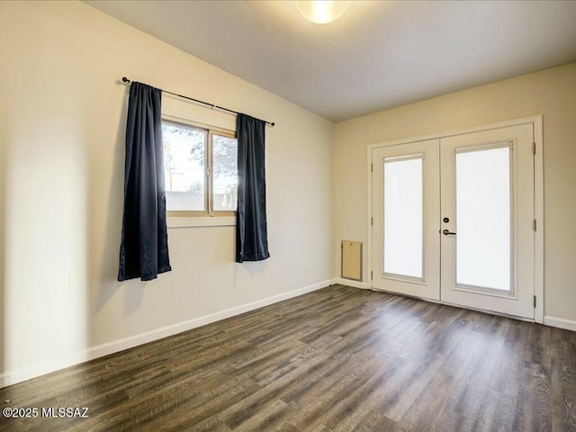 empty room featuring dark hardwood / wood-style floors and french doors