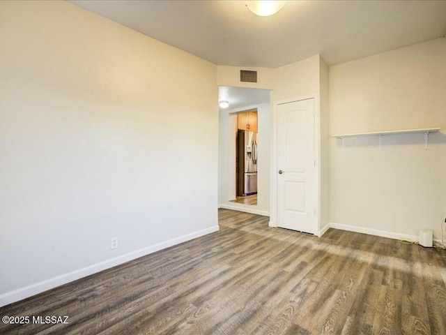 unfurnished room with hardwood / wood-style floors