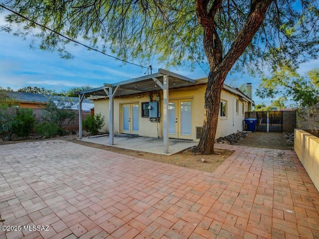 back of property featuring french doors and a patio area