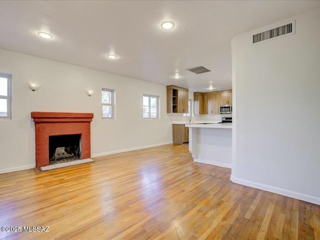 unfurnished living room featuring light hardwood / wood-style floors