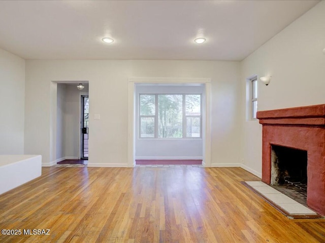 unfurnished living room featuring light hardwood / wood-style floors and a fireplace