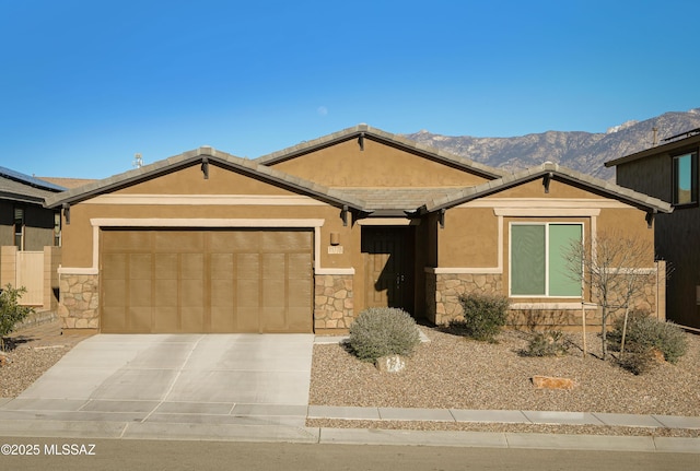 ranch-style home with a garage and a mountain view