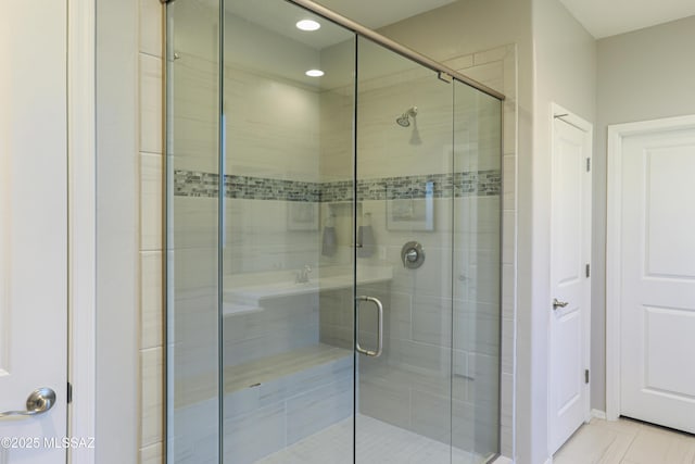 bathroom with a shower with shower door