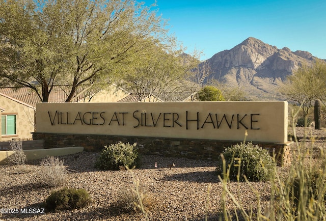 community / neighborhood sign with a mountain view