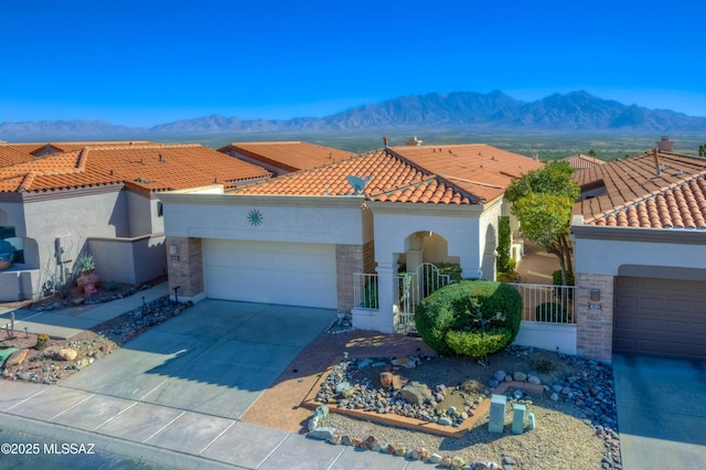 mediterranean / spanish home with a mountain view and a garage