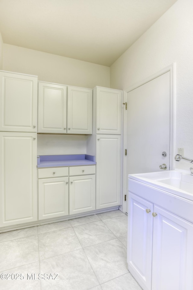 interior space featuring white cabinets and sink