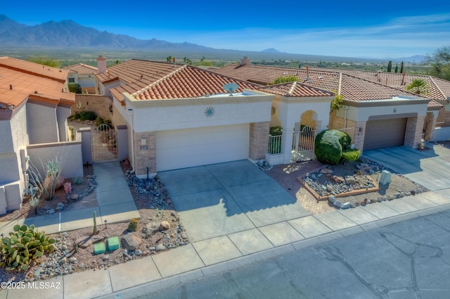 mediterranean / spanish-style house featuring a mountain view and a garage