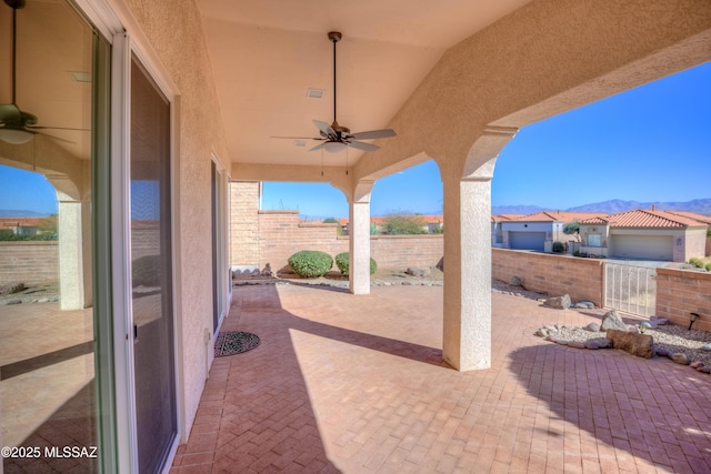 view of patio / terrace with a mountain view and ceiling fan