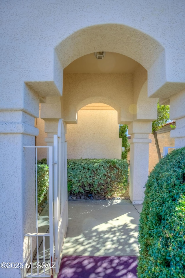 view of gate featuring a patio area