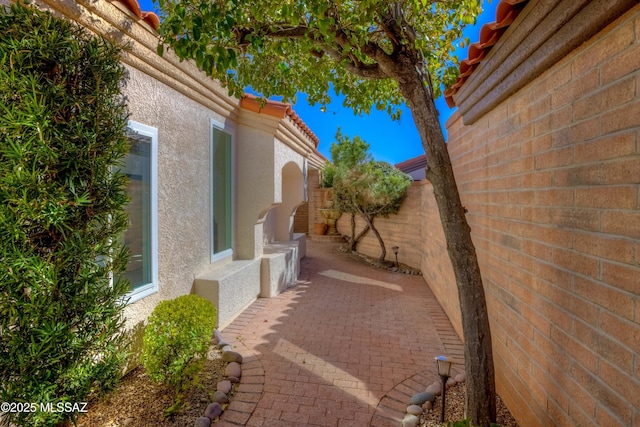 view of side of home featuring a patio area