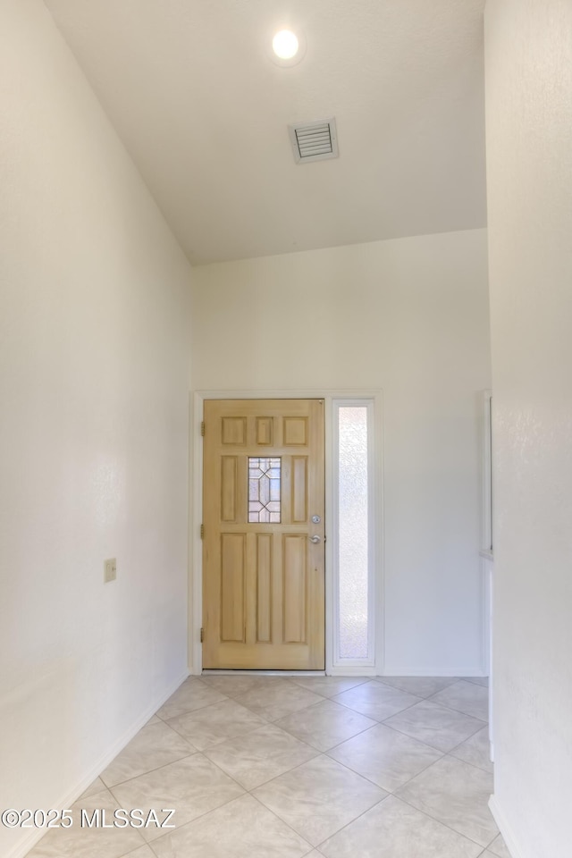 entrance foyer featuring high vaulted ceiling