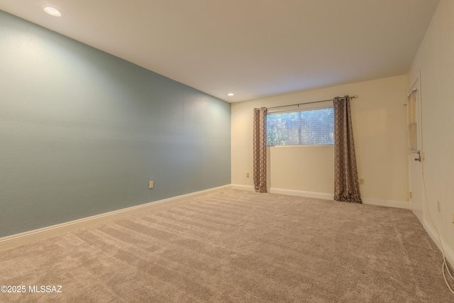 empty room with carpet, baseboards, and recessed lighting
