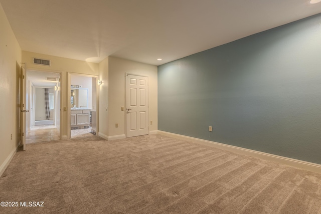 carpeted spare room with recessed lighting, visible vents, and baseboards