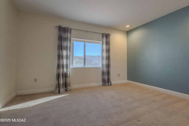 carpeted empty room featuring baseboards and recessed lighting