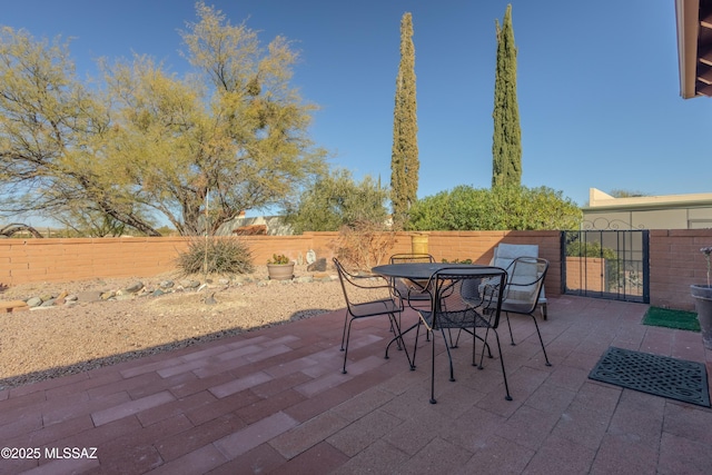 view of patio with outdoor dining area and a fenced backyard