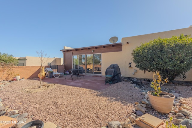 back of property featuring a patio area, fence, and stucco siding
