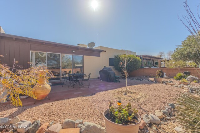 back of property with a patio area and fence