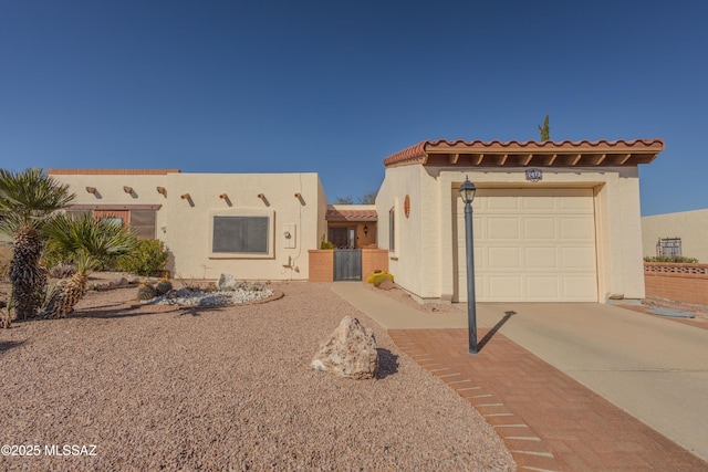 view of front of home featuring a garage, concrete driveway, a tiled roof, and stucco siding