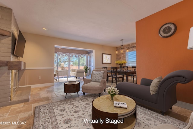 living room with stone tile floors and baseboards