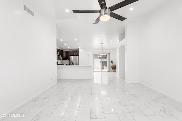 unfurnished living room with ceiling fan