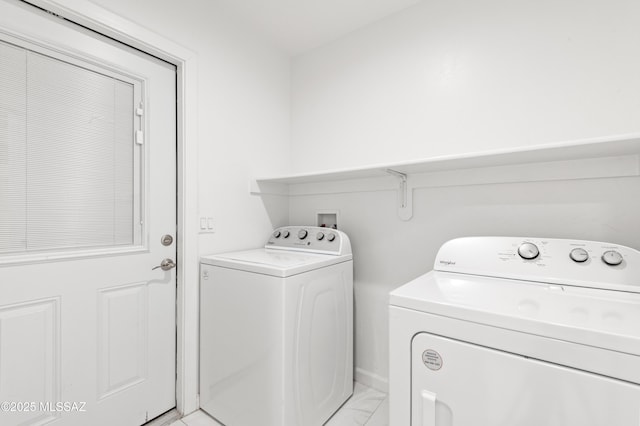 laundry area featuring washing machine and clothes dryer