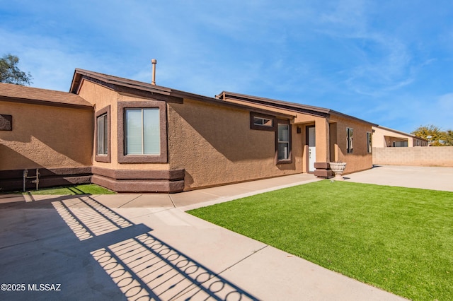 rear view of property with a patio area and a lawn