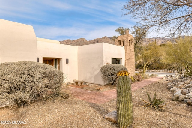 view of property exterior featuring a mountain view