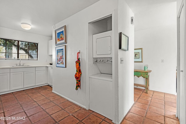 interior space with stacked washing maching and dryer and sink