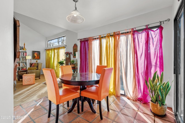 tiled dining area with lofted ceiling