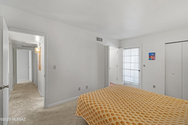 unfurnished bedroom with light carpet and a closet