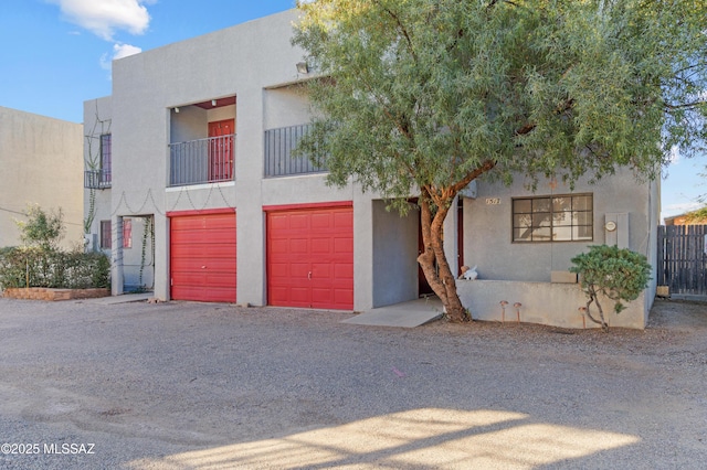 view of front of home with a garage and a balcony