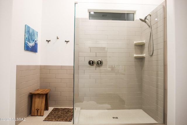 bathroom featuring tile patterned floors and tiled shower