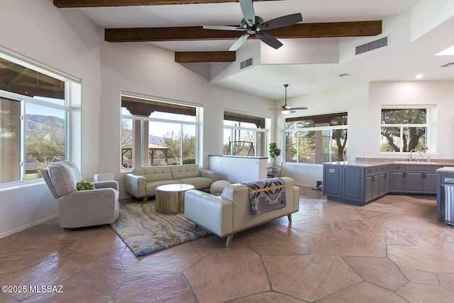 living room with sink, beamed ceiling, and ceiling fan