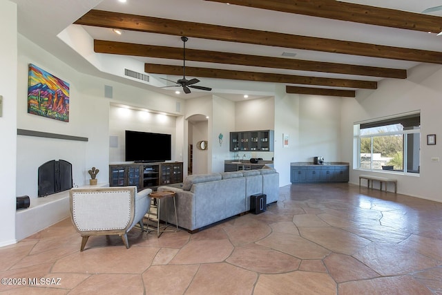 living room with ceiling fan and beam ceiling