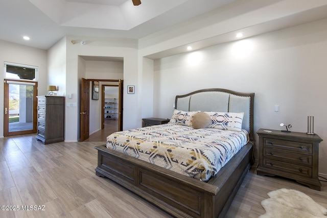 bedroom with access to outside, light hardwood / wood-style floors, and ceiling fan