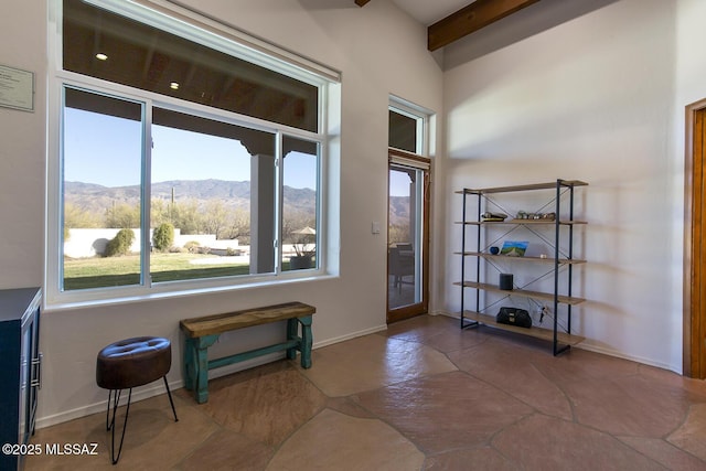 entrance foyer featuring a mountain view and beamed ceiling