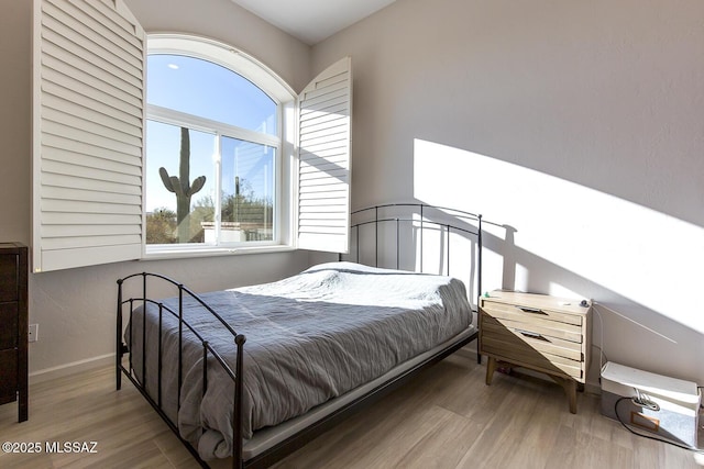 bedroom with wood-type flooring