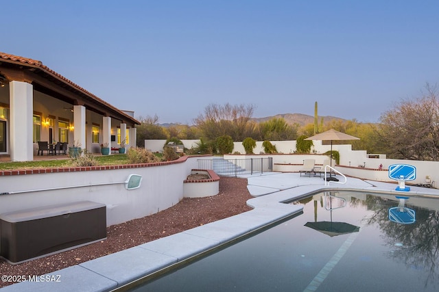 view of pool with a mountain view and a patio area