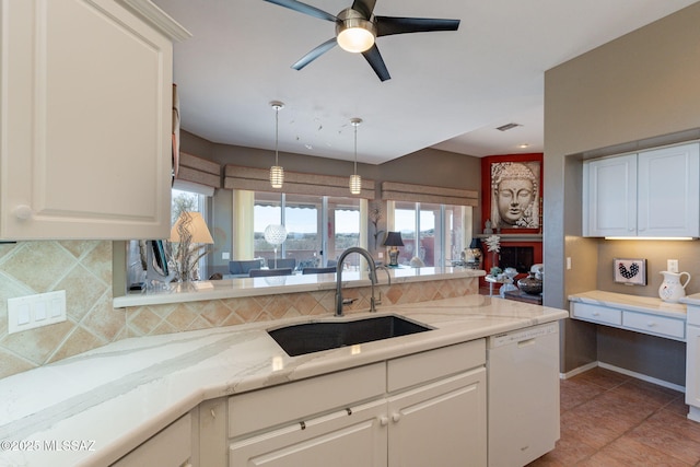 kitchen featuring tasteful backsplash, visible vents, dishwasher, white cabinetry, and a sink