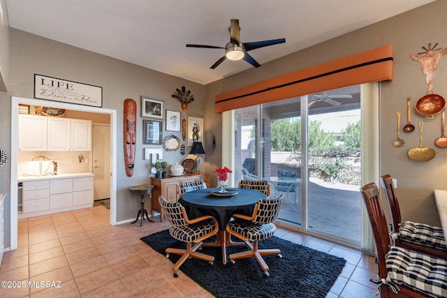 dining space with light tile patterned floors, baseboards, and a ceiling fan