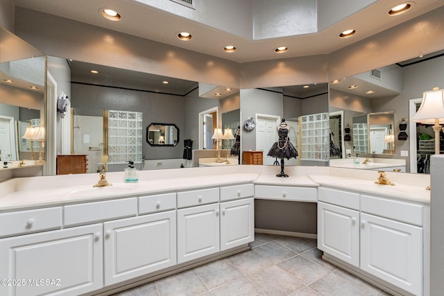 full bath featuring double vanity, a sink, and a shower with shower door