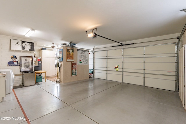 garage with washer / clothes dryer and a garage door opener