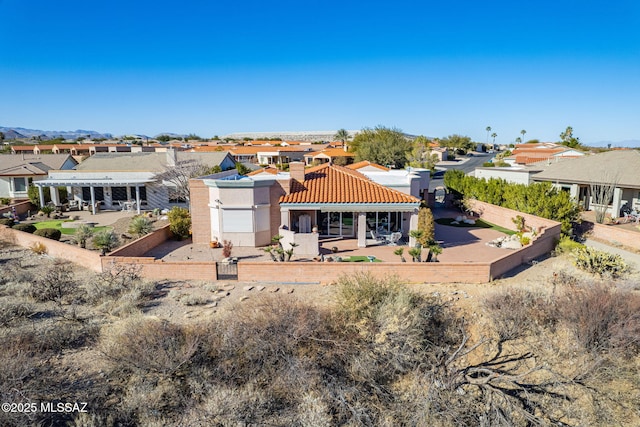 back of property featuring a patio, stucco siding, a pergola, a residential view, and a fenced backyard