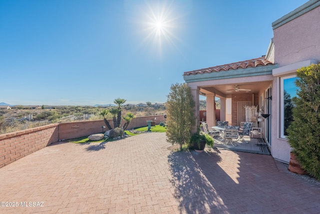 view of patio featuring fence and a ceiling fan