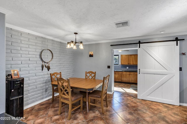 dining room with crown molding, brick wall, a barn door, and an inviting chandelier