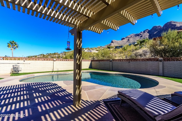 view of swimming pool with a pergola, a patio area, and a mountain view